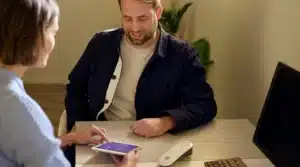 Professional showing AGE Scanner readings to male client to help him track his biological age