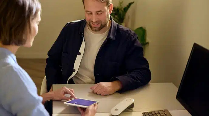 Professional showing AGE Scanner readings to male client to help him track his biological age